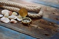 Nautical background. Old deck with rope, compass and shells