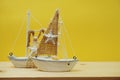 Nautical background with Sailboat Model on yellow background