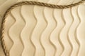 Nautical background of wavy sand with a rope Royalty Free Stock Photo