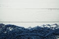 Nautical Blue Fishing net frame with space copy on wooden background