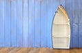 Nautical boat shape shelves on wooden table. product display background, vintage filtered Royalty Free Stock Photo
