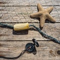 Nautical border with fishing net, sea shells and starfish on a b