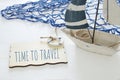 nautical concept image with white decorative sail boat and text over wooden board: TIME TO TRAVEL. Royalty Free Stock Photo