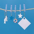 Nautical concept with sea lifestyle decorations hanging on rope. Sea toys lifeline, seastars and small fish