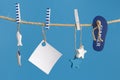 Nautical concept with sea lifestyle decorations hanging on rope. Sea toys lifeline, seastars and small fish