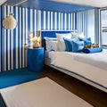 Nautical Escape: A beach-themed bedroom with blue and white stripes, seashell decorations, and a boat-shaped bed4, Generative AI