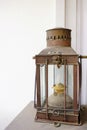 Nautical hurricane lantern dusty against white washed walls