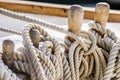 Nautical knotted ropes on wood cleats of old sailboat Royalty Free Stock Photo