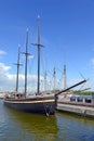 Nautical maritime scene with ropes and mast on a ship on a dock by the water