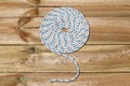Nautical rope in spiral shape on a  wooden  deck with copy space for your text Royalty Free Stock Photo