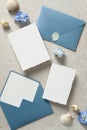 Nautical save the date cards mockups, blue envelopes, seashell on beige background. Wedding invitation card templates. Flat lay,