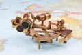 nautical sextant with optics, compass and ruler lying on paper world map Royalty Free Stock Photo