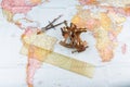 nautical sextant with optics, compass and ruler lying on paper world map Royalty Free Stock Photo