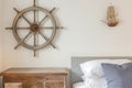 nautical steering wheel mounted on bedroom wall