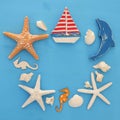nautical and summer holidays concept with sea life style objects, seashells and starfish over blue wooden background. Royalty Free Stock Photo