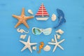 nautical and summer holidays concept with sea life style objects, seashells and starfish over blue wooden background. Royalty Free Stock Photo