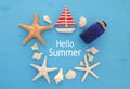 Nautical and summer holidays concept with sea life style objects, seashells and starfish over blue wooden background. Royalty Free Stock Photo