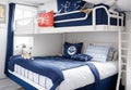 A nautical-themed bedroom with navy blue accents, ship-inspired decor,