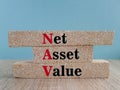 NAV Net Asset Value - company\'s total assets minus its total liabilities. Acronym text stamp on brick blocks. Beautiful blue