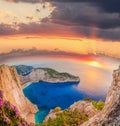 Navagio beach with shipwreck and flowers against sunset on Zakynthos island in Greece Royalty Free Stock Photo