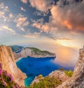 Navagio beach with shipwreck and flowers against sunset on Zakynthos island in Greece Royalty Free Stock Photo