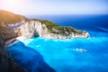 Navagio beach, Zakynthos island, Greece. Tourist trip boat leaving Shipwreck bay with deep turquoise water and white