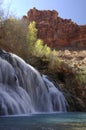 Navajo Falls, found in a single location before the 2008 flood, cascades over craggy red rock and in to a pool of blue green water