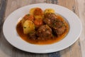 Navarin Lamb Shank Stew on wood table and and potatoes