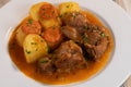 Navarin Lamb Shank Stew on wood table and and potatoes