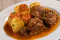 Navarin Lamb Shank Stew on wood table and and potatoes