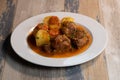 Navarin Lamb Shank Stew on wood table and and potatoes