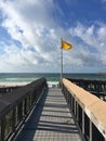 Navarre Beach, Florida, yellow caution flag and ramp to the beach. Royalty Free Stock Photo