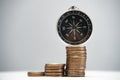 Navigational compass on a stack of coins with growth. Concept of investment strategy and success. Royalty Free Stock Photo