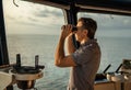 Navigational officer lookout on navigation watch with binoculars