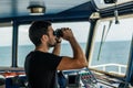 Navigational officer lookout on navigation watch looking through binoculars