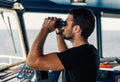 Navigational officer lookout on navigation watch looking through binoculars Royalty Free Stock Photo