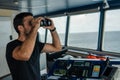 Navigational officer lookout on navigation watch looking through binoculars Royalty Free Stock Photo