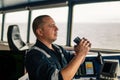 Navigational officer lookout on navigation watch looking through binoculars