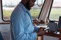 Navigator on the bridge looking at his cell phone Royalty Free Stock Photo