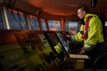 Navigator. pilot, captain as part of ship crew performing daily duties with VHF radio, binoculars on board of modern ship with