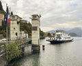 The Navigazione Laghi car ferry Ghisallo approaching the dock at Varenna for a trip to Menaggio. Royalty Free Stock Photo