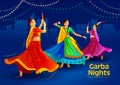 Girls in colourful dresses playing dandiya on Navaratri i.e festival of India. Garba on garba disco nights. Royalty Free Stock Photo