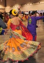 Group of Men and women are dancing and enjoying Hindu festival of Navratri Garba wearing traditional consume.