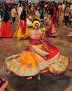 A young girl and group of people are enjoying Hindu festival of Navratri Garba wearing traditional consume.