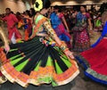 Group of Men and women are dancing in action. Enjoying Hindu festival of Navratri Garba wearing traditional consume.