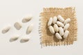 Navy Bean legume. Close up of grains spreaded over white table.