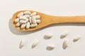 Navy Bean legume. Healthy grains on a wooden spoon. White background. Royalty Free Stock Photo