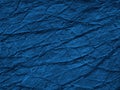 Navy blue abstract background. Toned rock surface texture with cracks and veins. Close-up. It looks like rough crumpled paper. Royalty Free Stock Photo