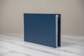 Navy blue leather album book - blank cover on isolated white wooden background Royalty Free Stock Photo