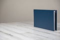 Navy blue leather album book - blank cover on isolated white wooden background Royalty Free Stock Photo